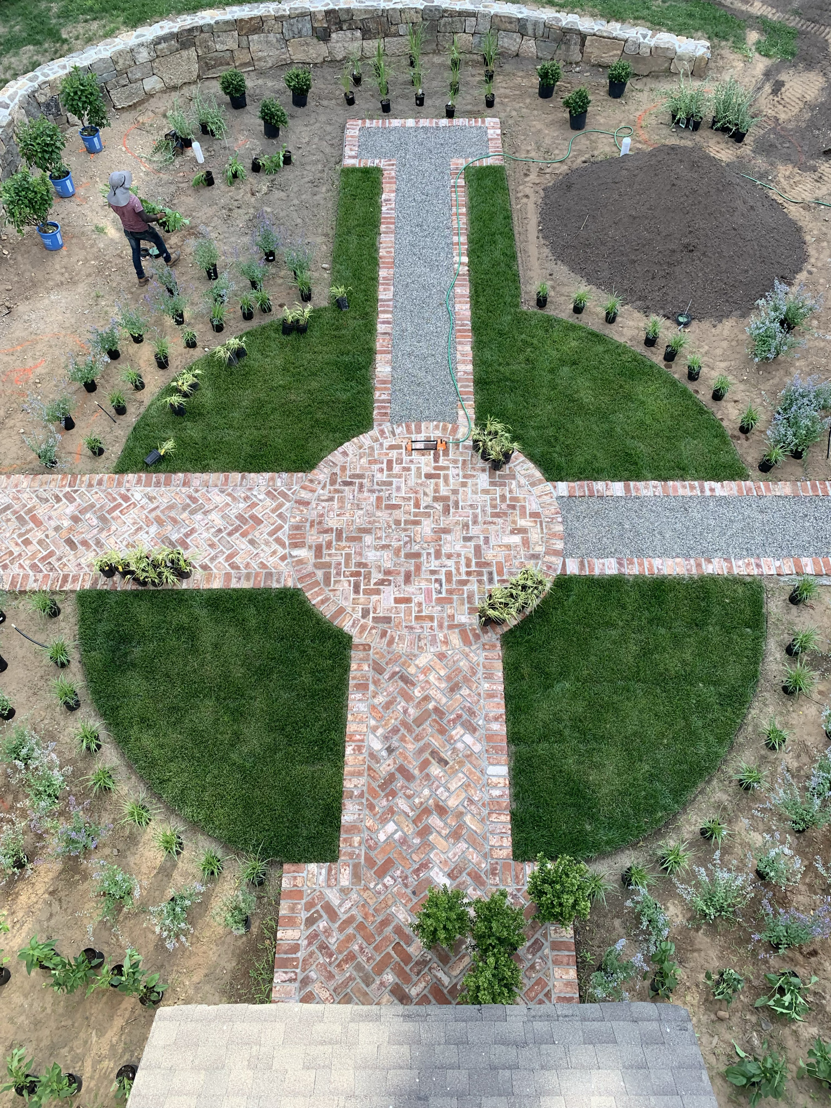 Aerial view of a formal garden with herringbone brick pathways and manicured lawns in Glenside, PA